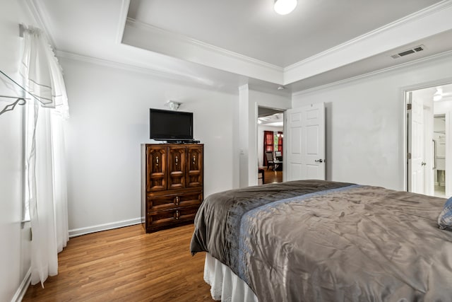 bedroom featuring ornamental molding and hardwood / wood-style floors