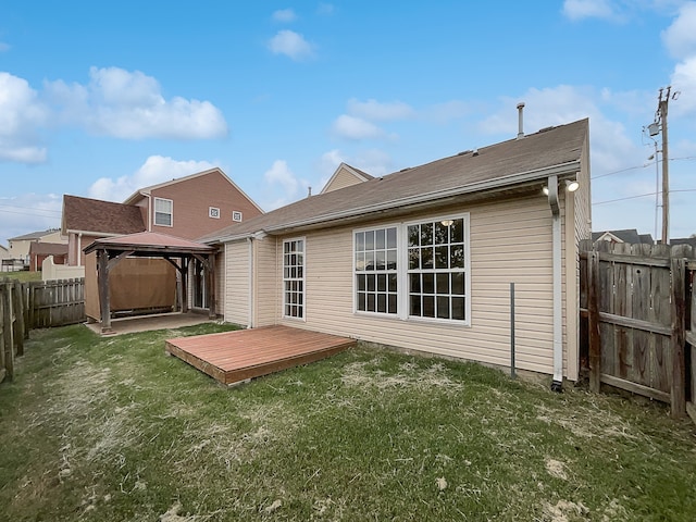 back of house featuring a gazebo, a deck, and a yard