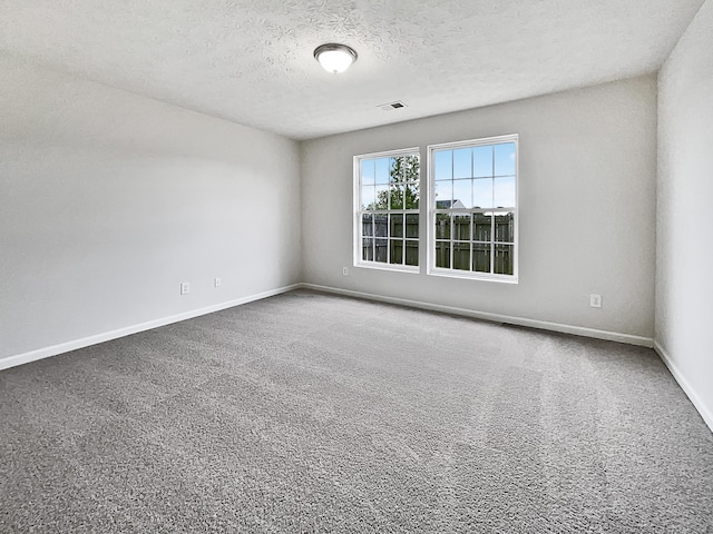 unfurnished room featuring a textured ceiling and carpet floors