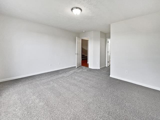 carpeted spare room with a textured ceiling