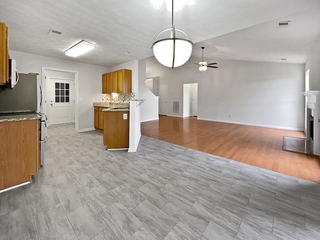 kitchen with kitchen peninsula, decorative backsplash, ceiling fan, light wood-type flooring, and vaulted ceiling