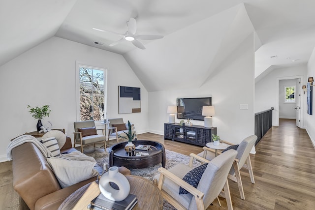 living room featuring hardwood / wood-style flooring, a healthy amount of sunlight, vaulted ceiling, and ceiling fan