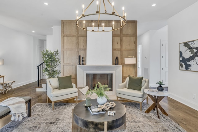 living room with hardwood / wood-style floors and a notable chandelier