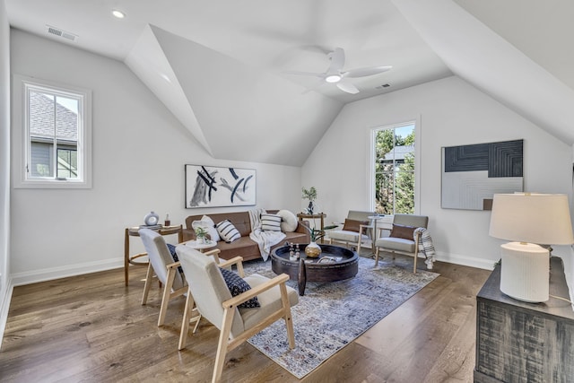 living room with ceiling fan, a healthy amount of sunlight, lofted ceiling, and dark hardwood / wood-style flooring