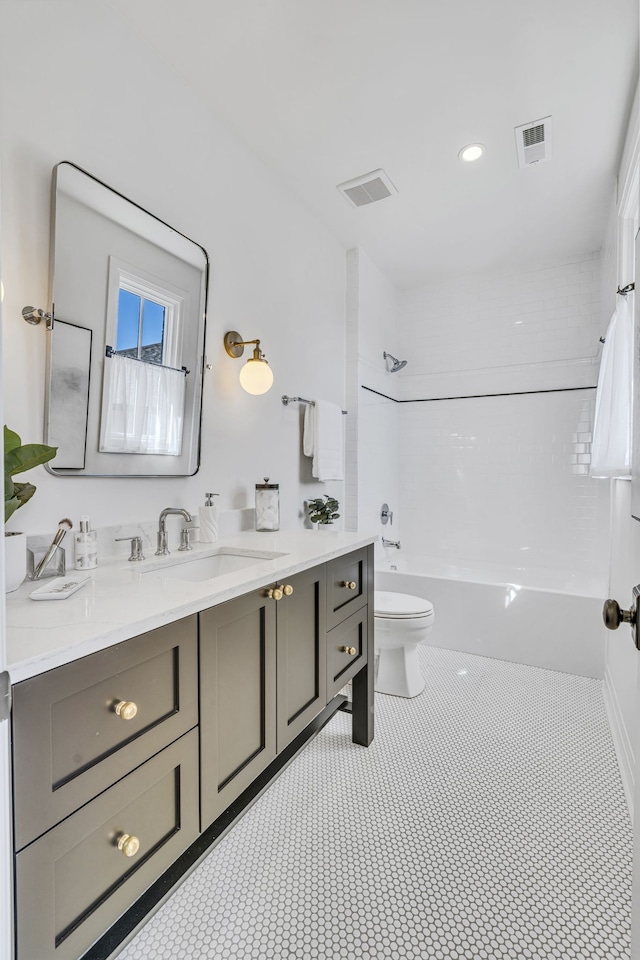 full bathroom featuring vanity, toilet, and tiled shower / bath