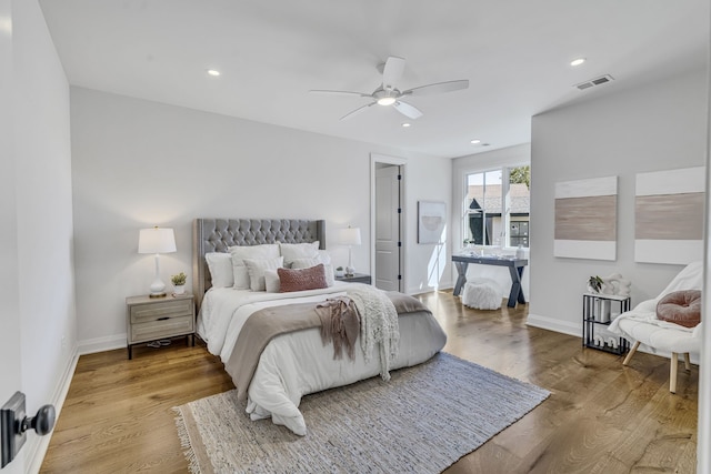 bedroom with light hardwood / wood-style floors and ceiling fan