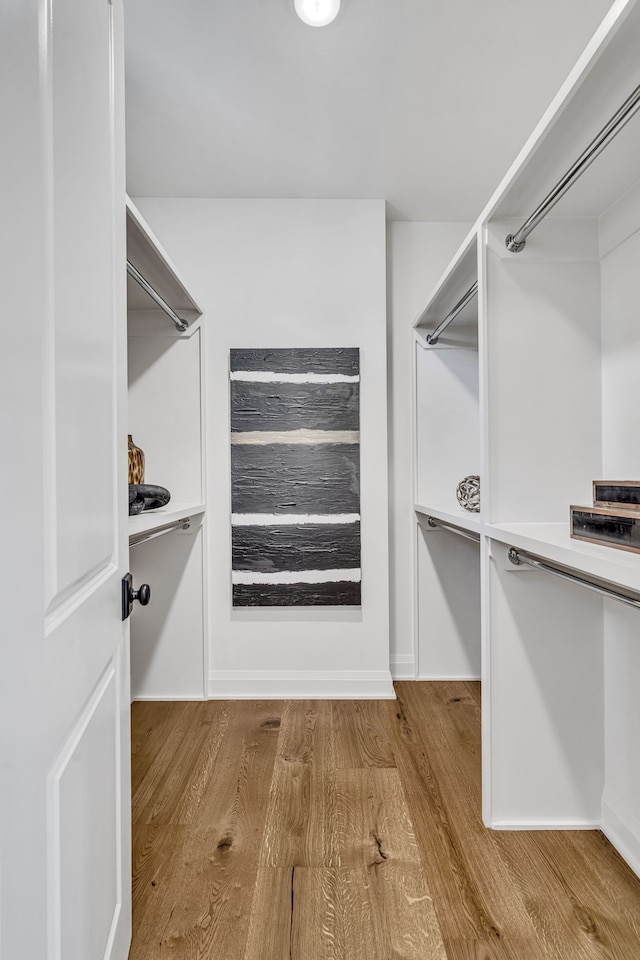 walk in closet featuring light hardwood / wood-style flooring