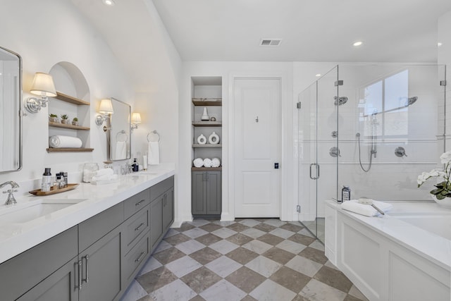 bathroom with vanity and independent shower and bath