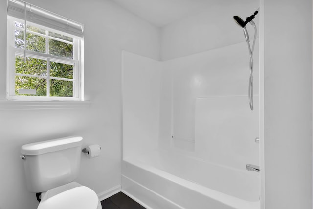 bathroom featuring toilet and tub / shower combination