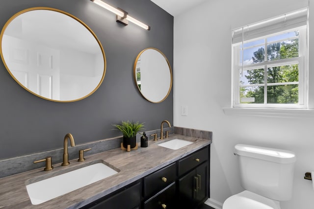 bathroom with toilet, hardwood / wood-style flooring, and vanity