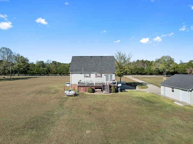 back of house featuring a wooden deck and a yard