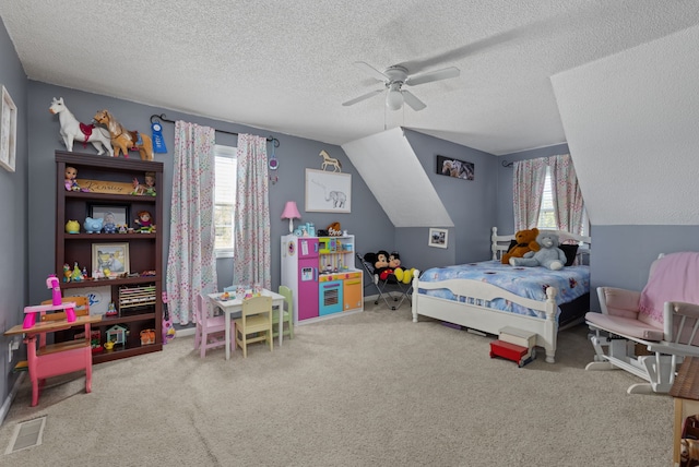 carpeted bedroom featuring a textured ceiling, vaulted ceiling, and ceiling fan