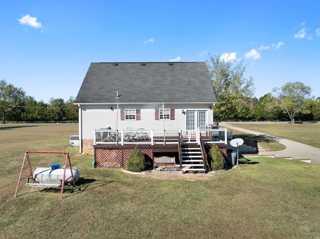 rear view of house with a deck and a lawn