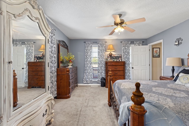 carpeted bedroom with a textured ceiling and ceiling fan