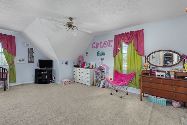 bedroom featuring lofted ceiling, carpet, a textured ceiling, and ceiling fan