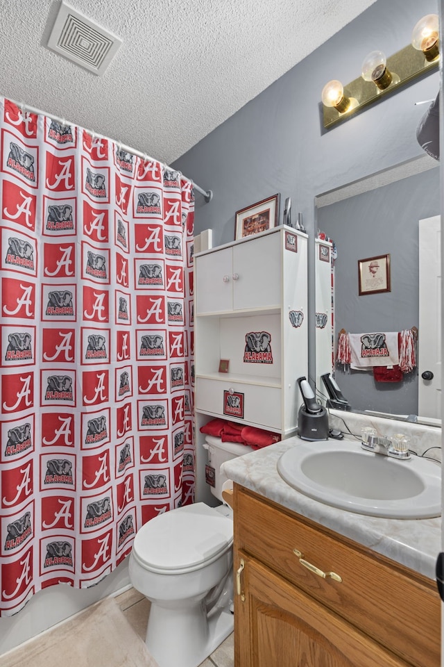 bathroom with curtained shower, a textured ceiling, toilet, tile patterned floors, and vanity