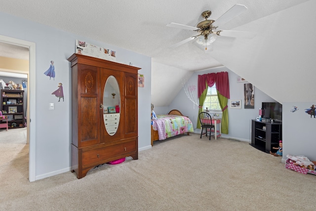 bedroom with lofted ceiling, light carpet, a textured ceiling, and ceiling fan