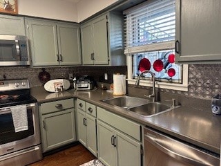 kitchen featuring appliances with stainless steel finishes, tasteful backsplash, and sink