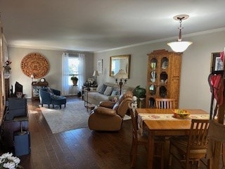 dining room featuring ornamental molding and dark wood-type flooring