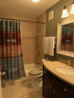 full bathroom with toilet, shower / bathtub combination with curtain, vanity, and tile patterned flooring