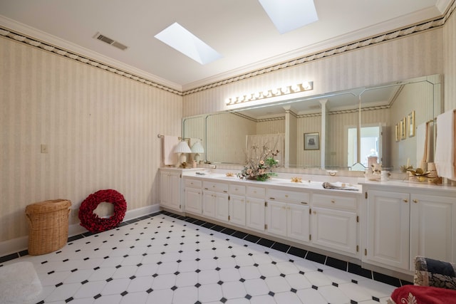 bathroom featuring vanity, ornamental molding, and a skylight