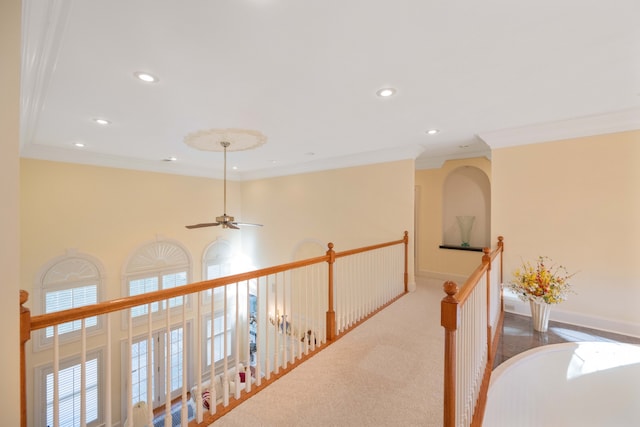 corridor featuring ornamental molding and carpet floors