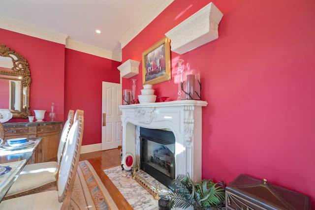 living area featuring crown molding and wood-type flooring