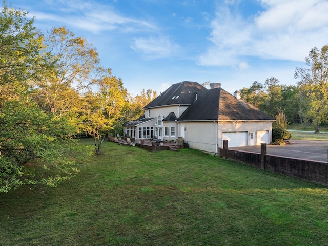 rear view of property with a yard and a wooden deck