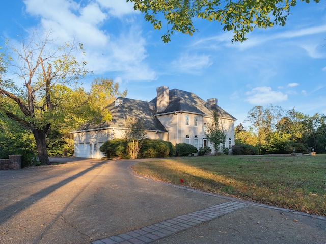 view of front facade with a front lawn and a garage