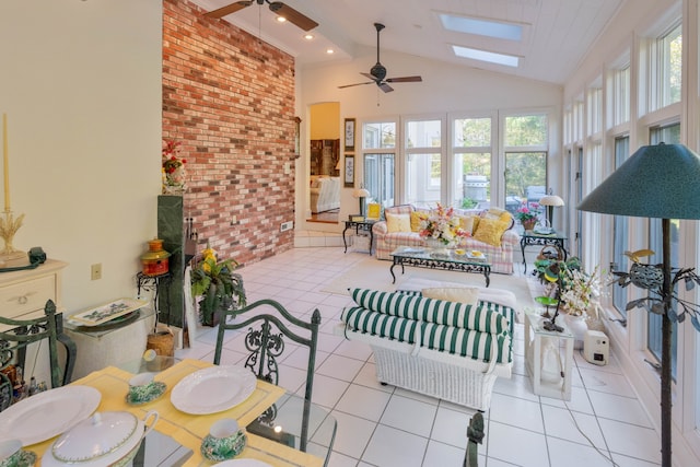 sunroom featuring lofted ceiling with skylight and ceiling fan