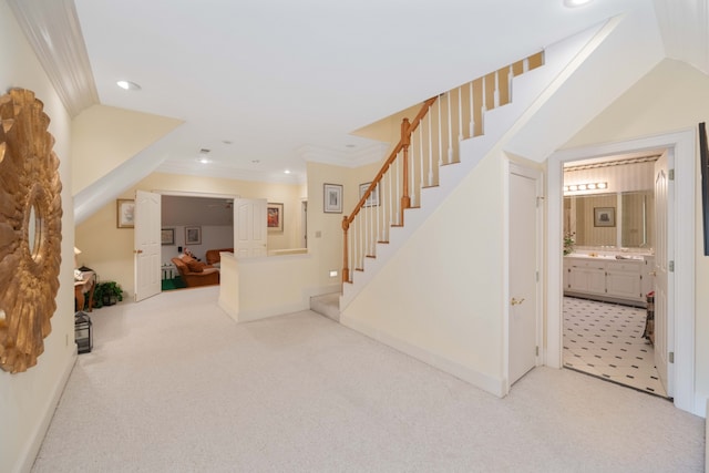 staircase featuring crown molding, carpet flooring, and vaulted ceiling