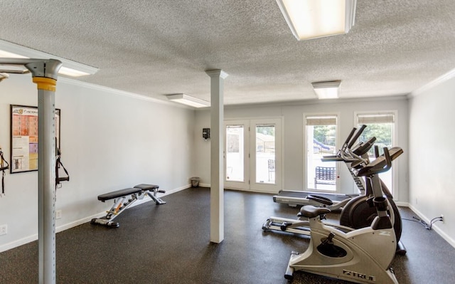 exercise room with ornamental molding and a textured ceiling