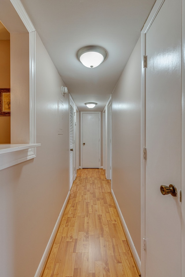 corridor with light hardwood / wood-style flooring