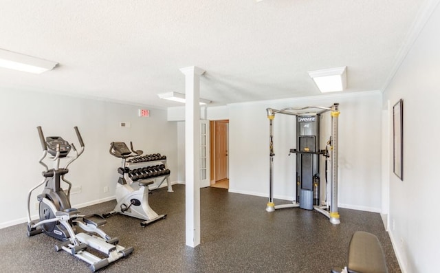 workout room featuring crown molding and a textured ceiling