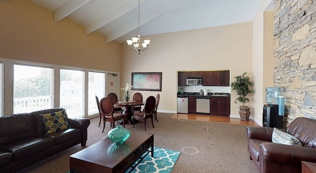 living room with high vaulted ceiling, beamed ceiling, light hardwood / wood-style flooring, and a chandelier