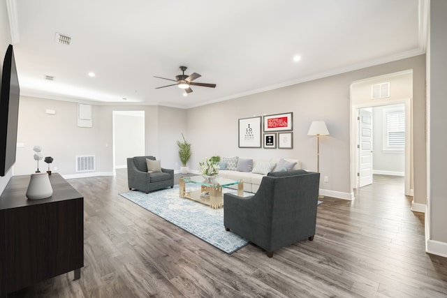 living room with ornamental molding, hardwood / wood-style flooring, and ceiling fan