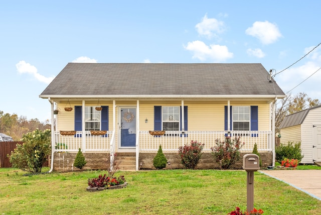 view of front of house with a front yard and covered porch