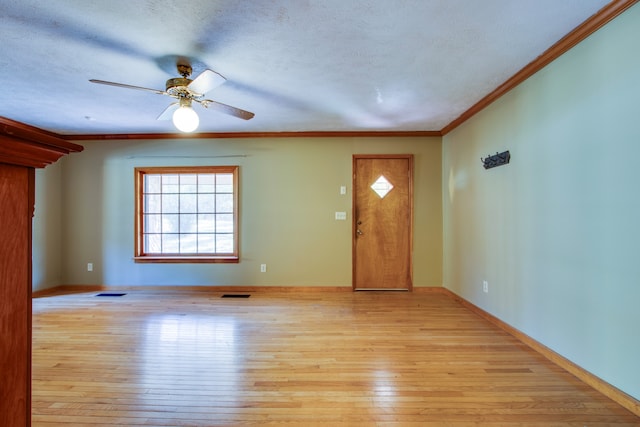 entryway featuring light hardwood / wood-style floors, a textured ceiling, ornamental molding, and ceiling fan