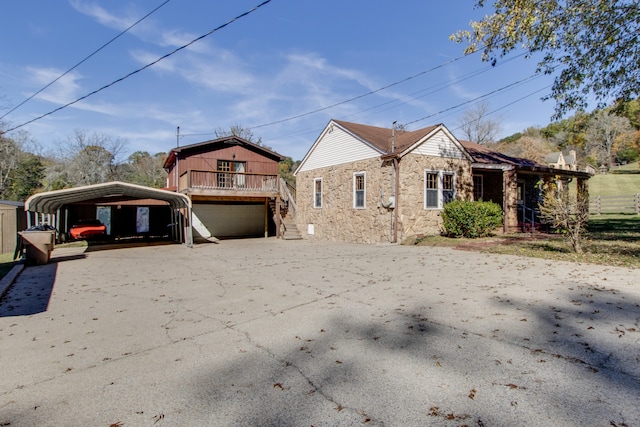 view of home's exterior with a garage and a carport