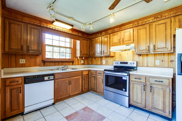 kitchen with dishwasher, stainless steel electric range oven, and wood walls