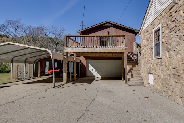 back of property with a garage and a carport