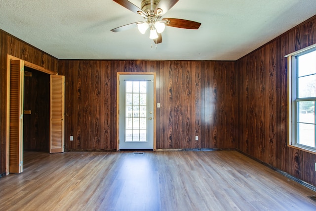 empty room with ceiling fan, light hardwood / wood-style flooring, and a wealth of natural light