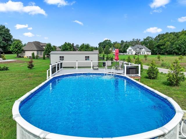 view of swimming pool with a patio area and a lawn