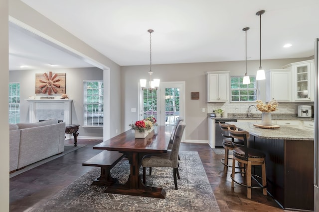 dining area featuring a wealth of natural light and an inviting chandelier