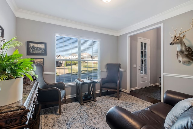 living area featuring crown molding and hardwood / wood-style flooring