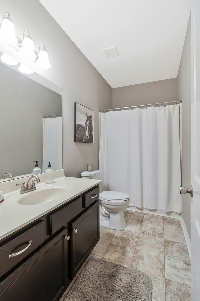 bathroom featuring vanity and toilet