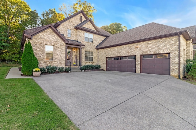 view of front of house featuring a garage and a front lawn