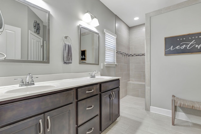 bathroom featuring vanity and a tile shower