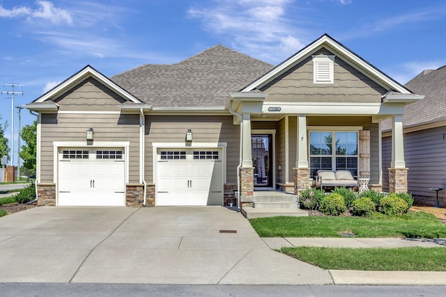 craftsman inspired home with a porch and a garage