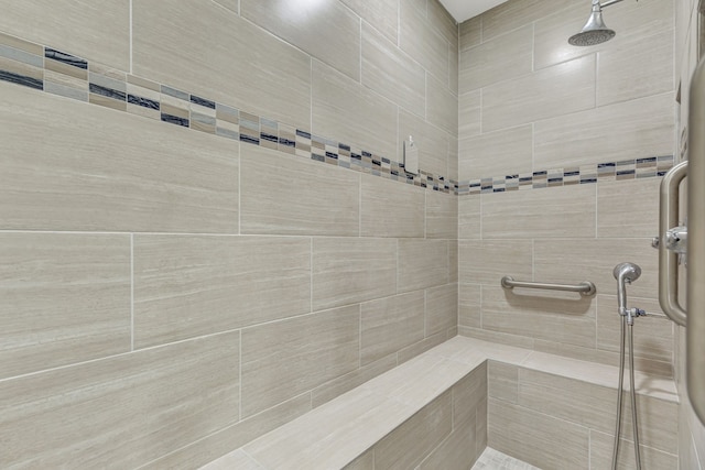 bathroom with a tile shower